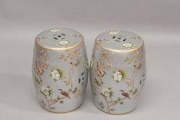 A PAIR OF CHINESE SILVER GROUND POTTERY BARREL SEATS. 1ft 6ins high.