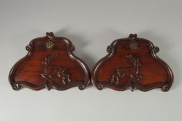 A GOOD PAIR OF FINELY CARVED PANELS with stags. 10.5ins wide.
