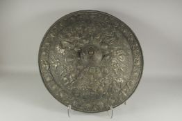 A RENAISSCENCE METAL CIRCULAR SHIELD repousse with figures. 24ins diameter.