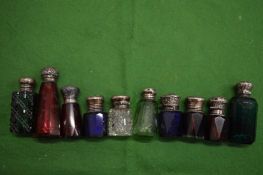 A collection of silver topped coloured scent bottles.