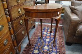 A mahogany demi-lune fold over card table.