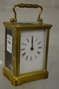 A brass carriage clock.