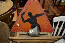 A brass bell, a log basket and an unusual painting.