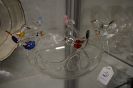 An unusual moulded glass bowl decorated with colourful birds to the rim.