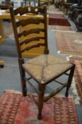 A set of six elm and rush seated ladder back dining chairs.