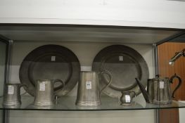 Two pewter dishes, graduated set of three pewter tankards and two other items.