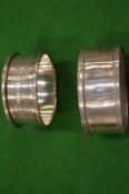 Two silver napkin rings.