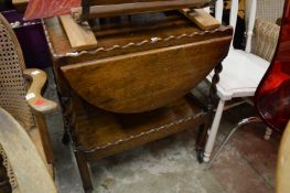 An oak drop-flap two tier tea trolley.
