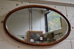 Two mahogany oval mirrors.