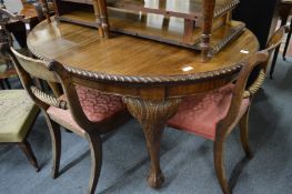 A mahogany oval extending dining table with two leaves on carved cabriole legs with claw and ball