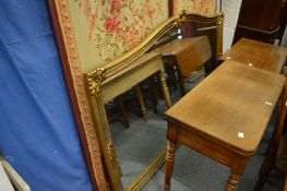 A large gilt framed over-mantle mirror.