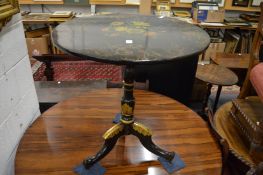 A good ebonised floral decorated and parcel gilded tilt-top occasional table.