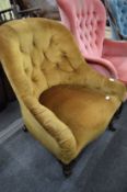 A Victorian rosewood and button upholstered armchair.