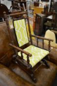 A good American child's rocking chair with modern upholstered back and seat.