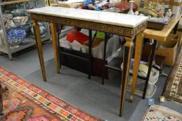 A marble topped ebonised and parcel gilded console table with Greek key frieze.