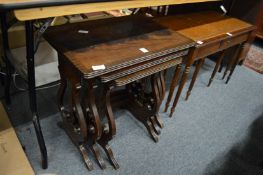 A nest of mahogany lyre end tables.