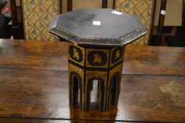 A small Eastern black lacquer and gilt decorated octagonal shaped occasional table with folding