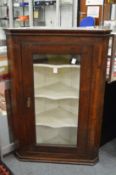 An oak hanging corner cabinet.