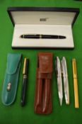 A Mont Blanc roller ball pen, boxed, a Cartier fountain pen, a Lynx pen set and a Michel Jordi pen