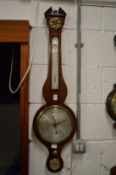 A mahogany cased barometer and thermometer.