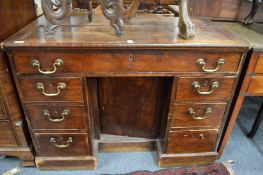 A 19th century mahogany kneehole desk (faults).