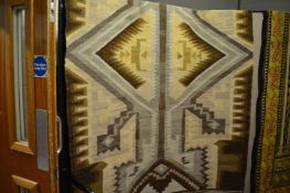 A large Kelim carpet of geometric design in autumnal colours 230cm x 154cm.