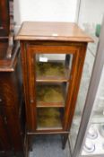 An inlaid mahogany pedestal display cabinet.