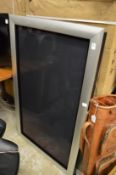 A Bang & Olufsen large flat screen TV.