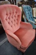 A pink draylon button upholstered armchair.