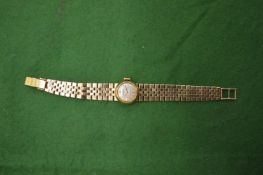A Ladies Rolex 18ct gold wristwatch with 18ct gold curb link bracelet strap.