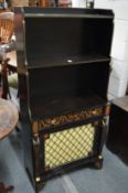 A pair of Regency style Egyptian revival ebonised and painted waterfall pier cabinets with brass