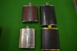 Four hip flasks.