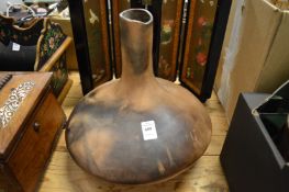 A large squat shaped pottery vase.