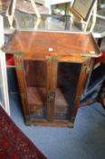 A pair of Chinese elm two door cabinets, each fitted with small drawers and shelves to the