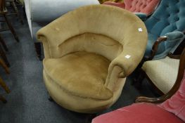 A Victorian horseshoe shaped upholstered armchair.