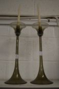 A pair of stylish glass candlesticks.
