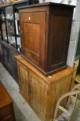 An oak single door cupboard and a pine two door cupboard.
