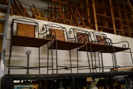 A set of four wrought iron armchairs.