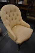 A Victorian mahogany framed and button upholstered bedroom chair.