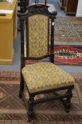 A set of four high back dining chairs with upholstered back panels and seats.