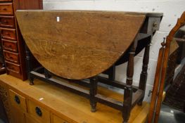 A 19th century oak oval drop-leaf gate-leg dining table.