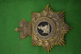 A Norfolk Regiment helmet badge.