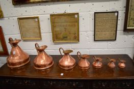 A graduated set of seven copper Haystack measures.