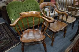 Two beech and elm spindle back armchairs.
