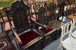 A carved oak Wainscott style armchair with matching side chair and two similar occasional chairs.