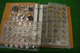 An album containing a mixed group of coins and notes.