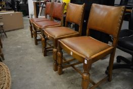 A set of four oak dining chairs.