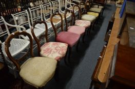 Seven various Victorian walnut dining chairs.