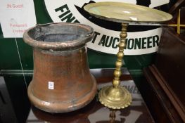 A large Eastern copper pot and a brass pedestal stand.