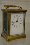 A brass carriage clock.
